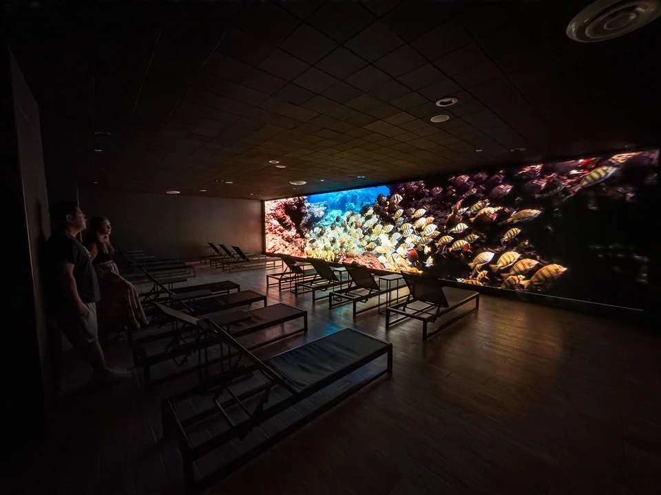 Wall-spanning LED display behind lounge seating at Balian Spring Crystal Spa