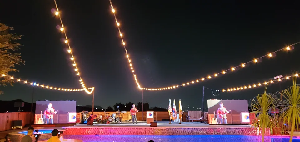Live performance imagery on the two event screens.