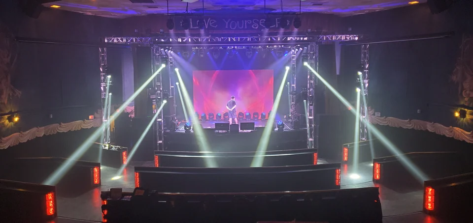 Stage and lighting preparation in a tiered venue.