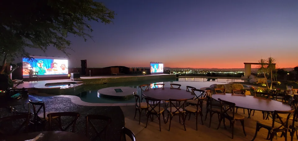 Displays and audience tables at dusk.